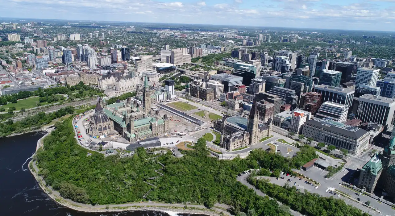 Aerial view of downtown Ottawa, including Parliament Hill and surrounding government buildings.