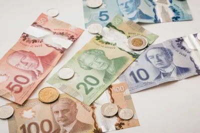 Canadian money including bills and coins laid out on a table